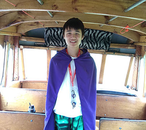 Fa’aumu dressed as “Incognito the Transit Hero” with purple cape and a white shirt, green pants and a red lanyard