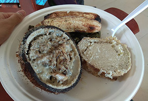 Taro, fish, and bananas on a white plate.