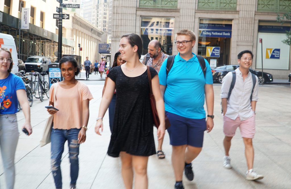 Five students walking on the sidewalk in NYC