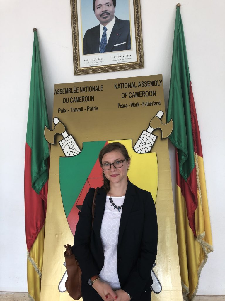 SIT alumna Sasha Lansky in front of flags and symbols at the National Assembly of in Cameroon