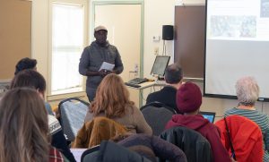 Kenneth Mukonyezi presents his research at the December 2018 Capstone Seminar.