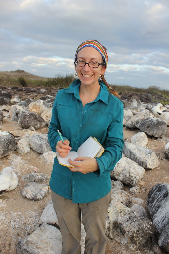 Jenny Howard writing in her notebook in the Galapagos