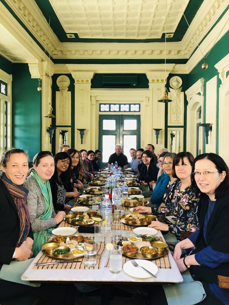 Long table of food with more than 15 diners