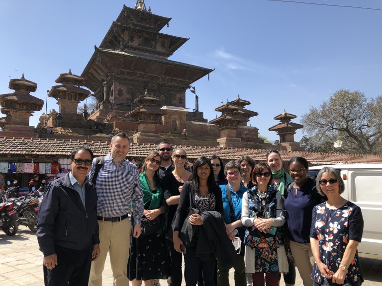 Group standing in front of a large building in Kathmandu