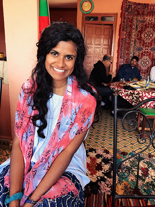 Young woman with floral scarf in a Moroccan home