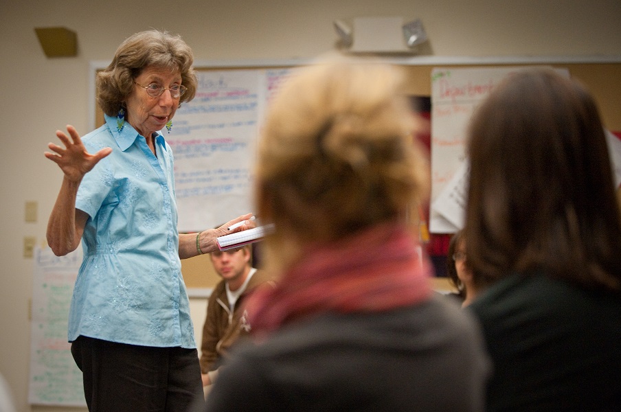 A woman speaks to a group of students