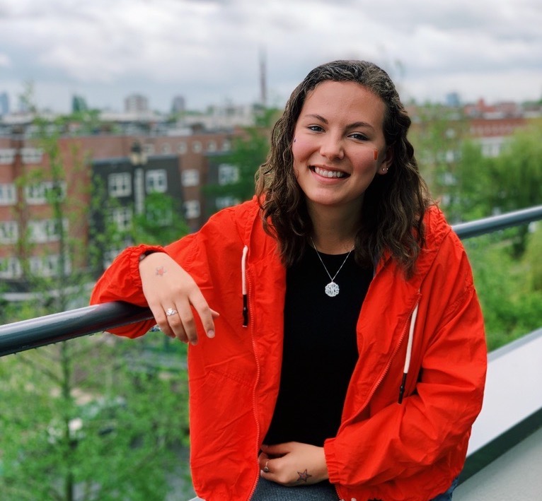 Alia Nahra poses on a balcony overlooking Amsterdam.