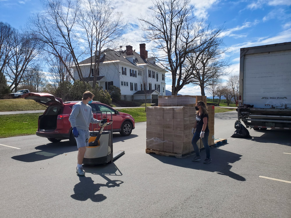 The Vermont Foodbank distributes boxes of food during an event on campus in April 2021.