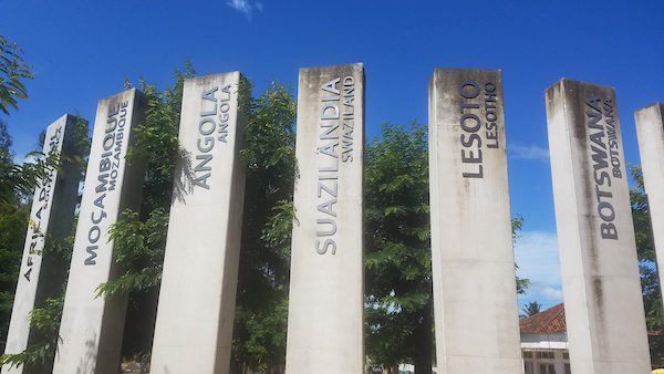 Six tall concrete pillars with the French and English names of African countries.