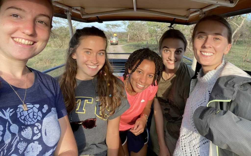 Five young people in an automobile on safari