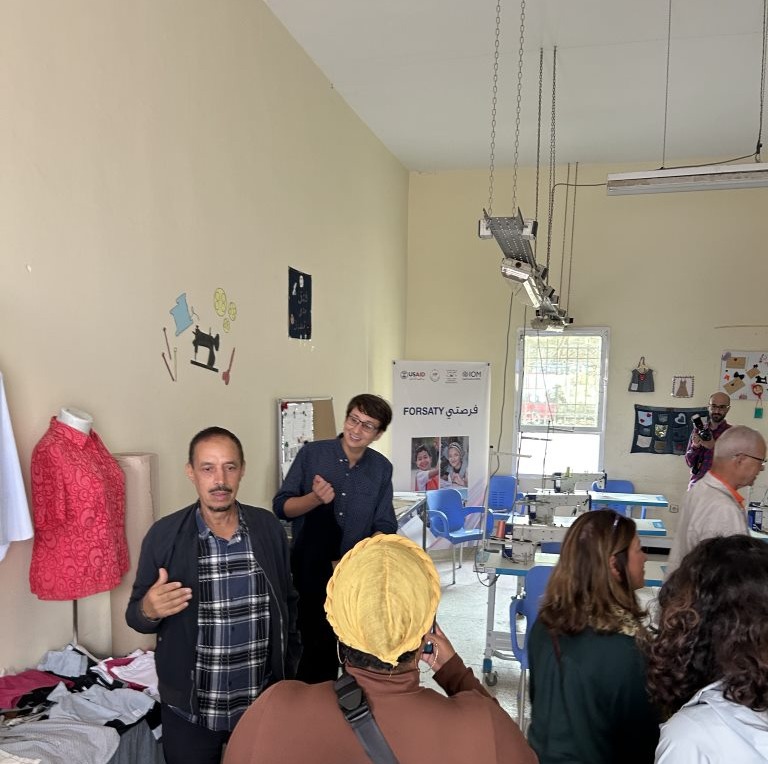 A small group of people in a sewing workshop.