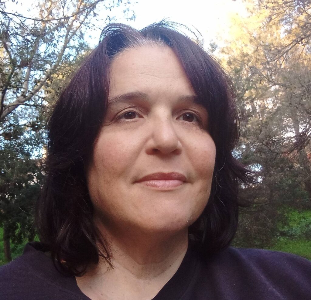 A headshot of Carolina Castro Huercano in a forested area.